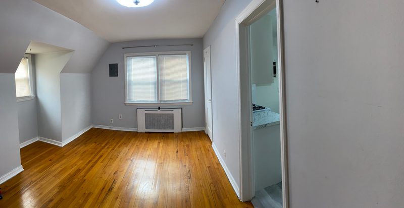 Wide view of a main room with hardwood floors