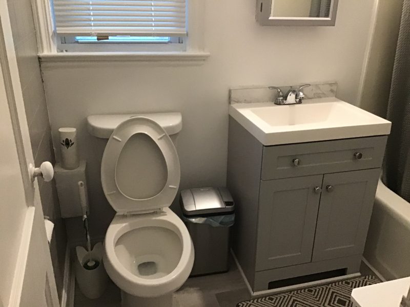 Bathroom with a vanity, toilet and window